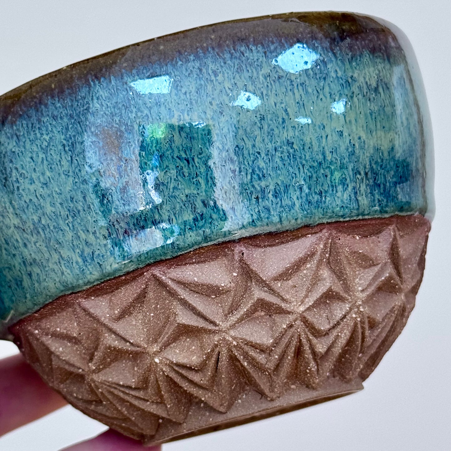 Handmade ceramic cappuccino cup carved green close