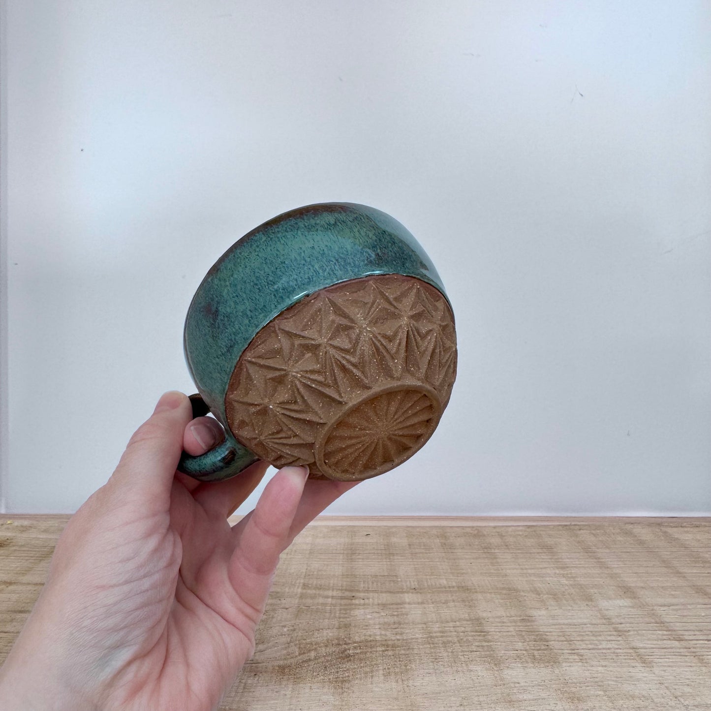 Handmade ceramic cappuccino cup carved green hand