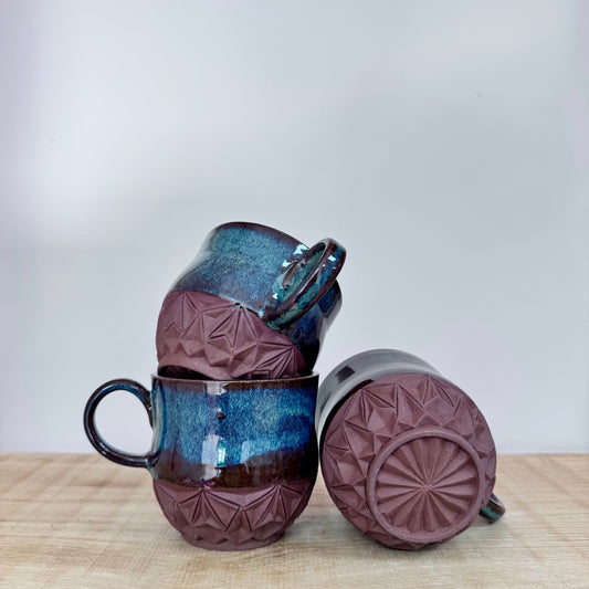 Handmade ceramic mugs carved